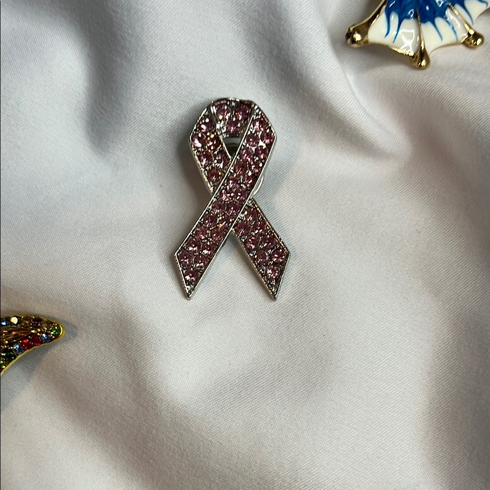 Breast Cancer Awareness Pin with pink rhinestones.